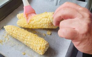 Brushing Garlic Butter Onto Corn